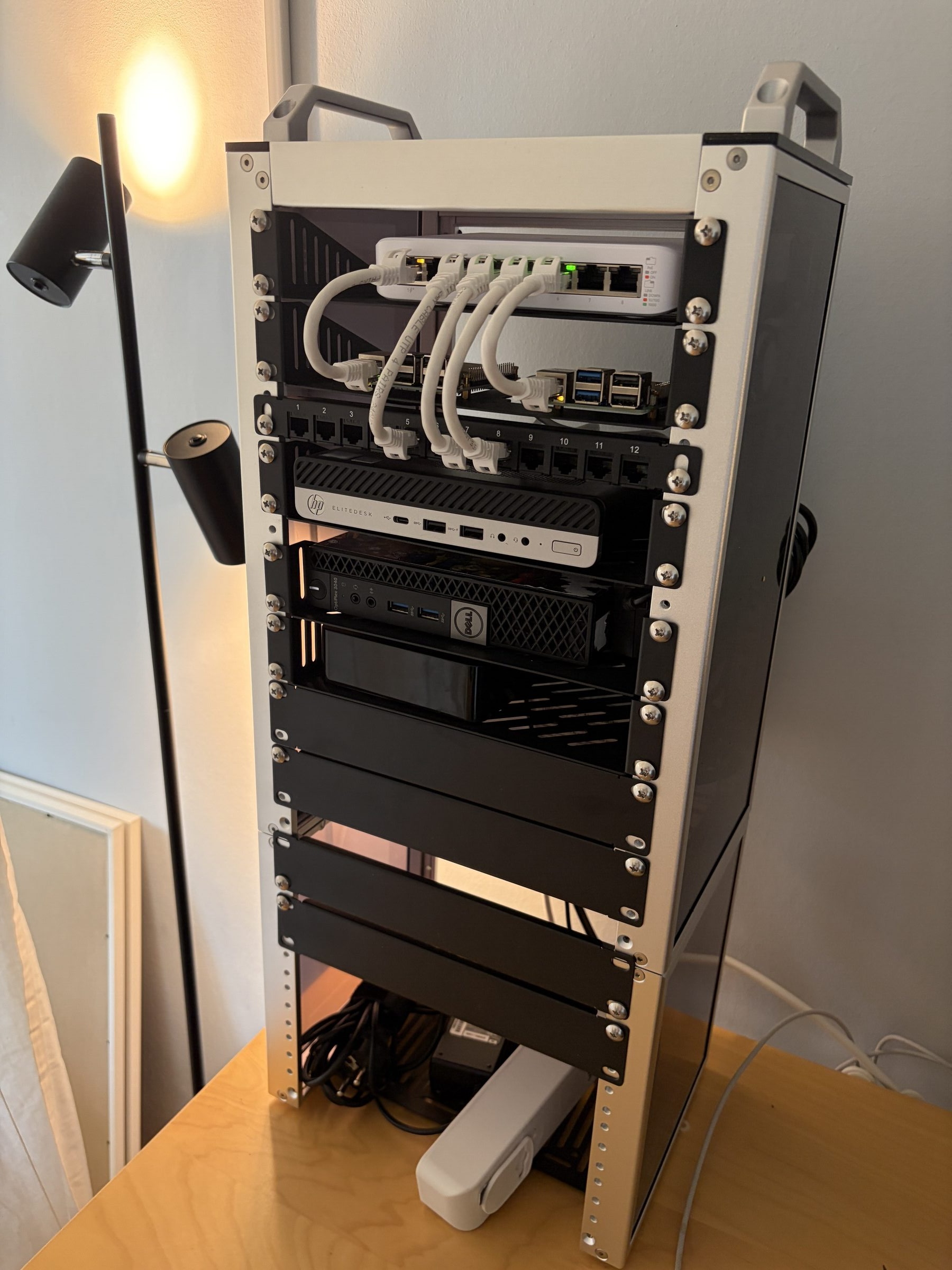 Image of a 10 inch server rack with computers, cable and a network switch